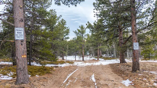 a view of wooden fence and trees