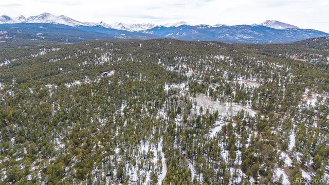 a view of a mountain range with lush green hillside