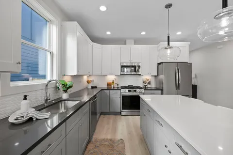 a sink with white cabinets
