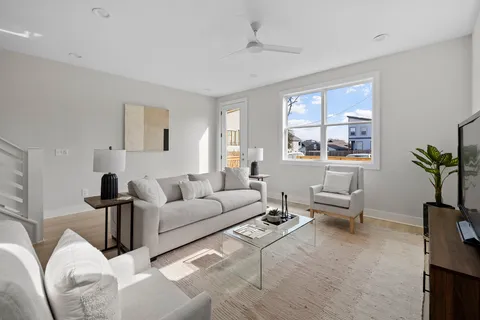 a living room with furniture and wooden floor