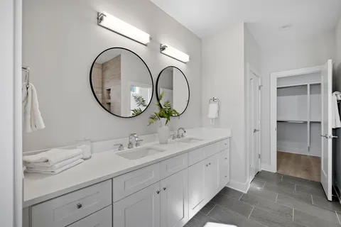 a bathroom with a double vanity sink and a mirror