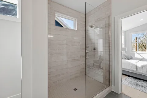 a bedroom with a bed and a chair