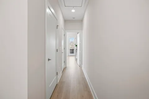 a view of a hallway with wooden floor