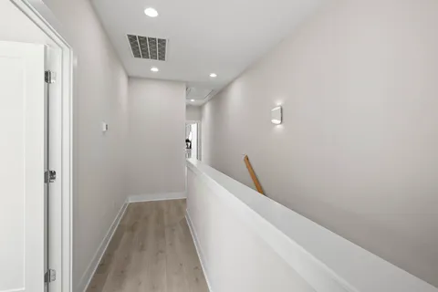 a spacious bathroom with a double vanity sink a large mirror and a shower