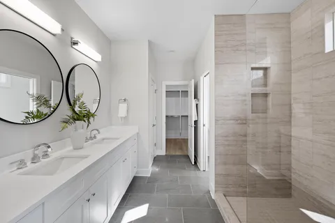 a bathroom with a toilet a sink a mirror and a bathtub