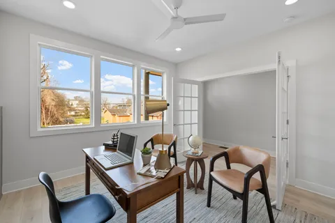 a bathroom with a granite countertop toilet a sink and a mirror