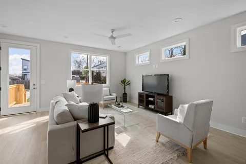 a open kitchen with stainless steel appliances kitchen island granite countertop a table chairs and a refrigerator