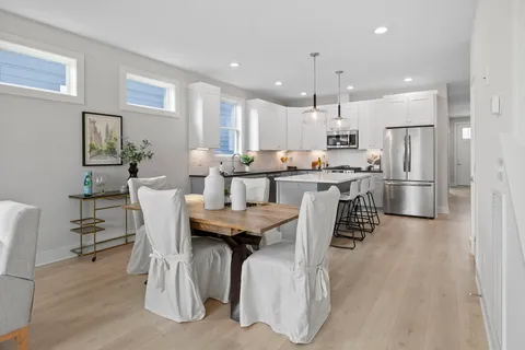 a living room with furniture kitchen view and a table