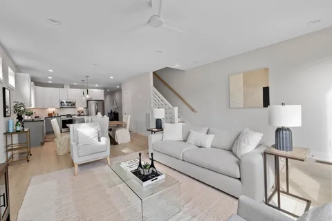 a kitchen with stainless steel appliances white cabinets and a stove a refrigerator a sink