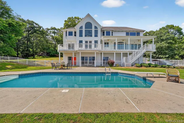 a view of a swimming pool with an outdoor seating