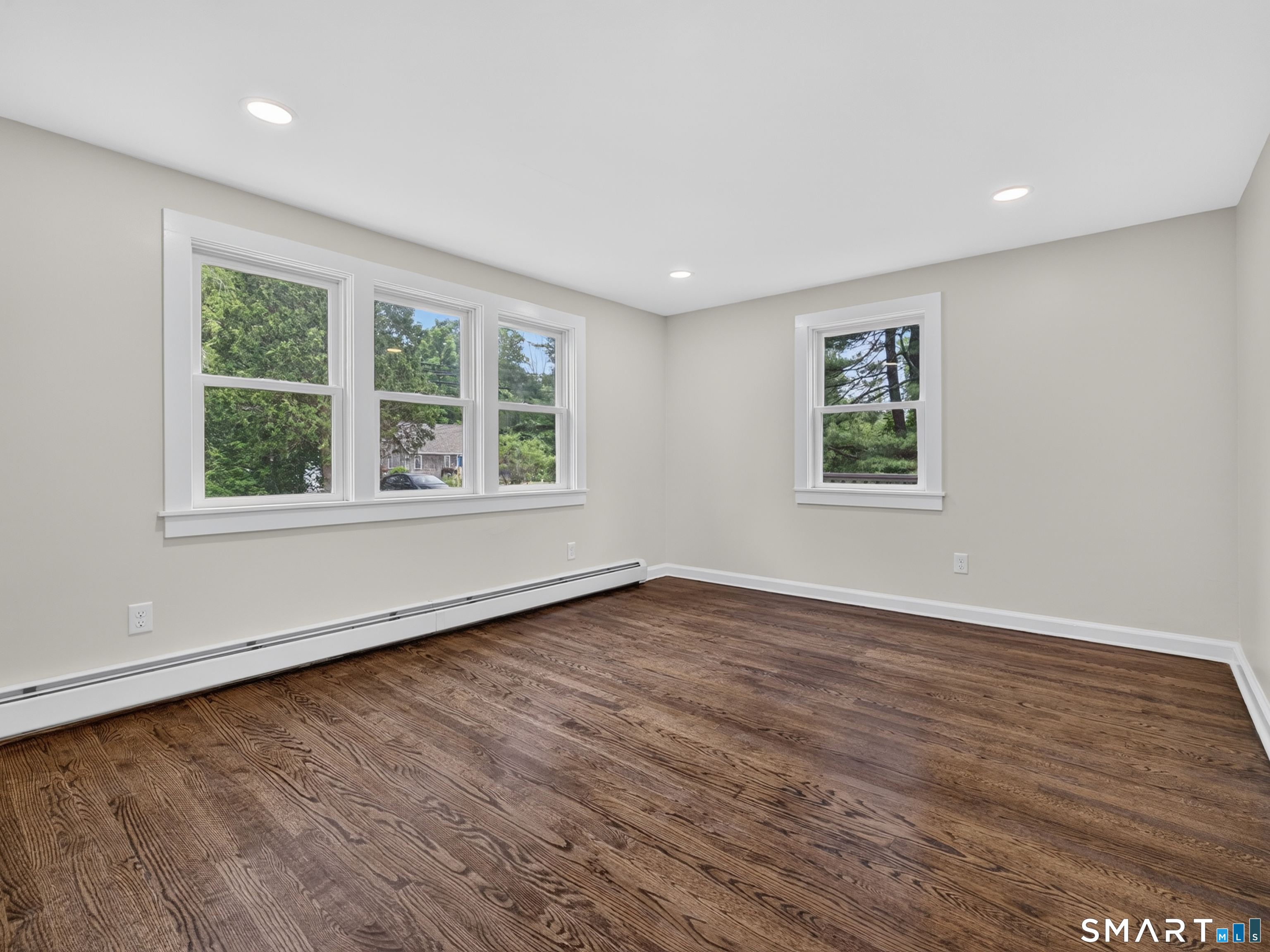 1039 N Road Groton, CT 06340 - Photo 5 of 26 an empty room with wooden floor and windows