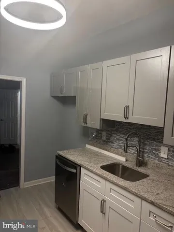 a kitchen with a sink and cabinets