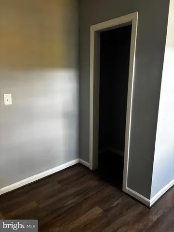 an empty room with wooden floor