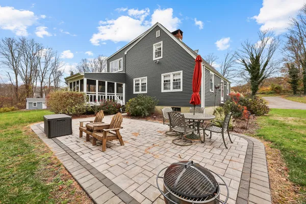 a view of a house with backyard porch and sitting area