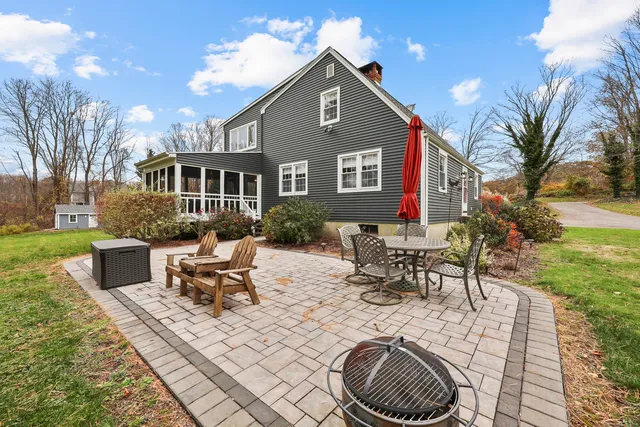 a view of a house with backyard porch and sitting area