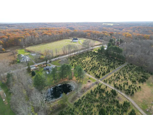 an aerial view of mountain with residential house and green space