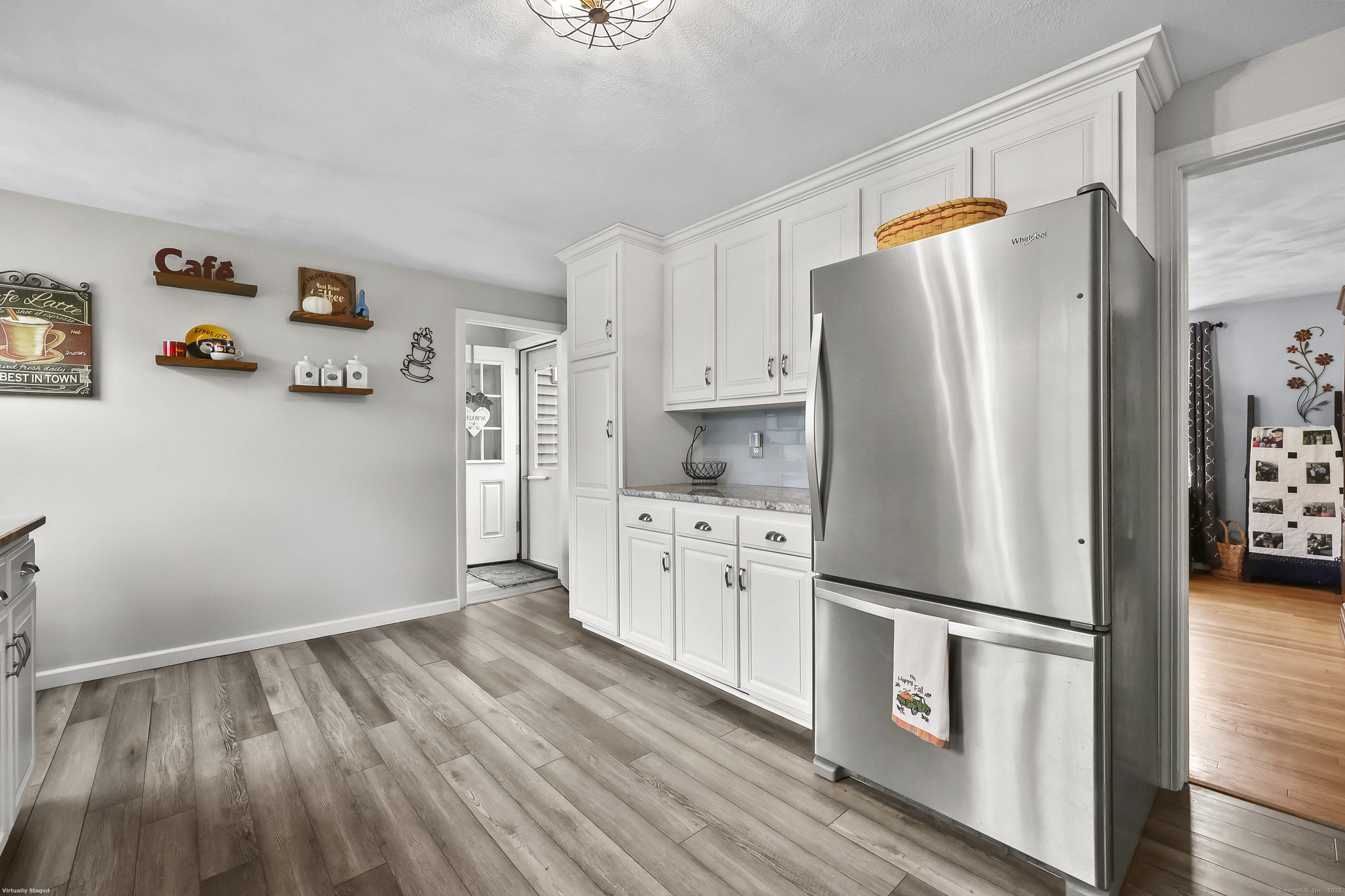 559 East Street Hebron, CT 06248 - Photo 3 of 31 a kitchen with stainless steel appliances a refrigerator a stove a sink and white cabinets with wooden floor