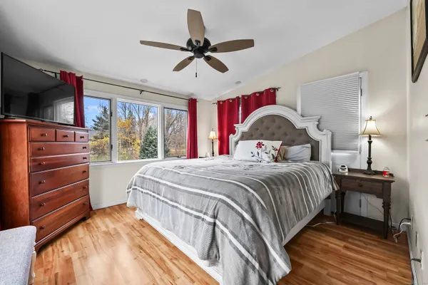 a bedroom with a bed and a large window