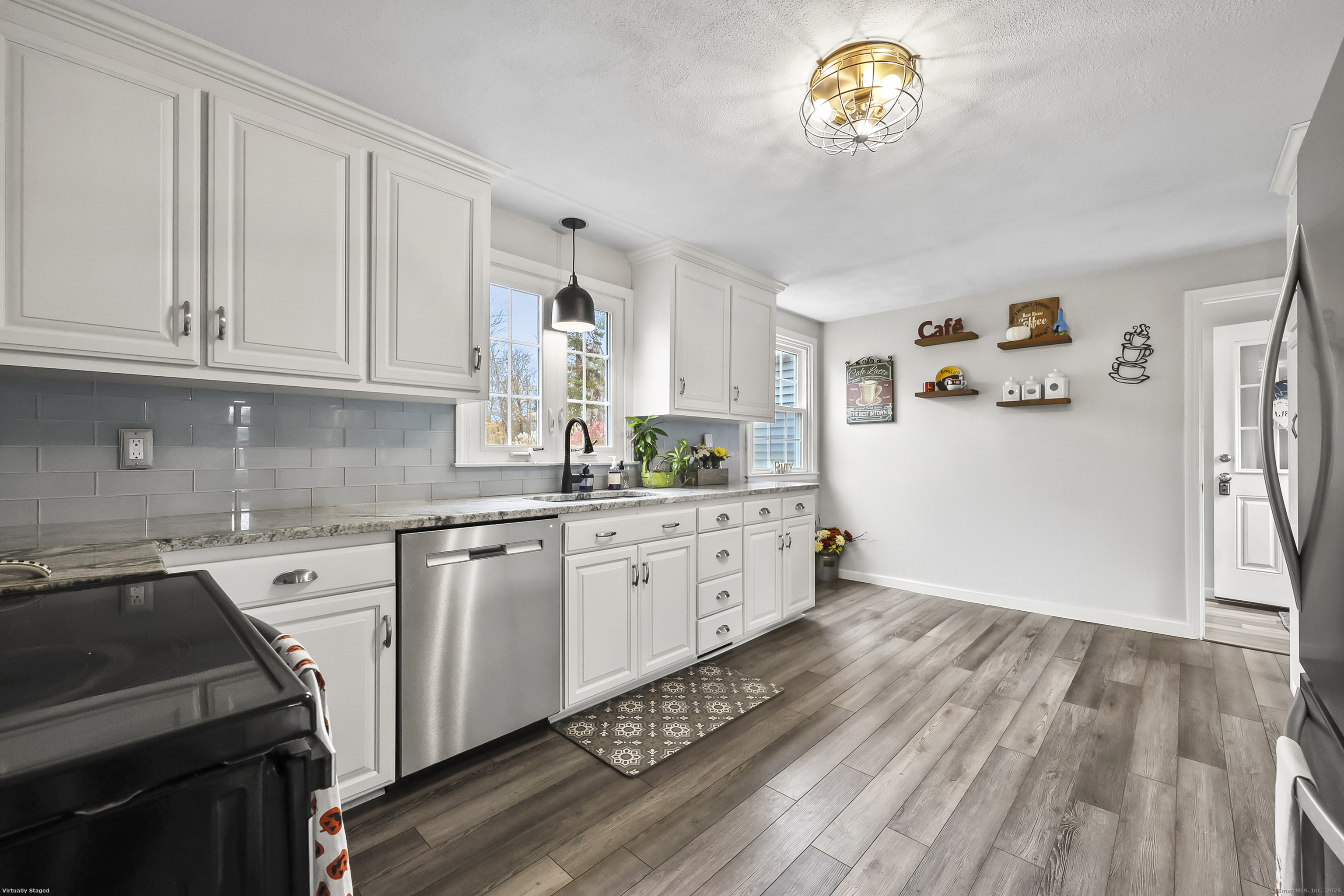 559 East Street Hebron, CT 06248 - Photo 5 of 31 a kitchen with granite countertop a white stove top oven and white cabinets