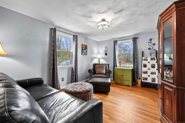 a bedroom with furniture and a wooden floor