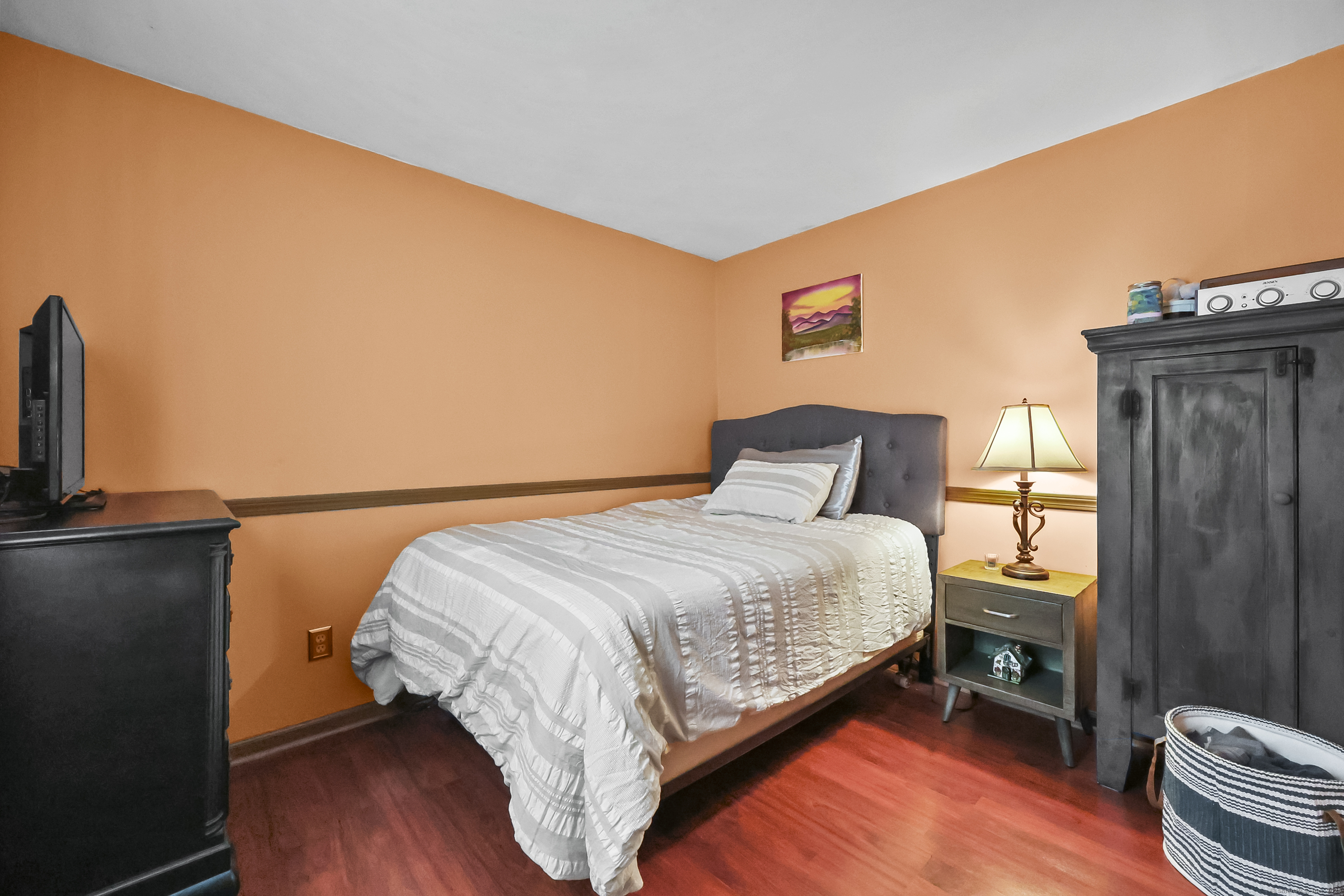 559 East Street Hebron, CT 06248 - Photo 10 of 31 a bed sitting in a bedroom next to a window with wooden floor