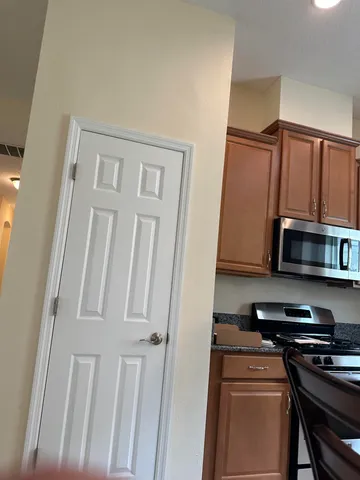 a kitchen with stainless steel appliances granite countertop a stove and a microwave