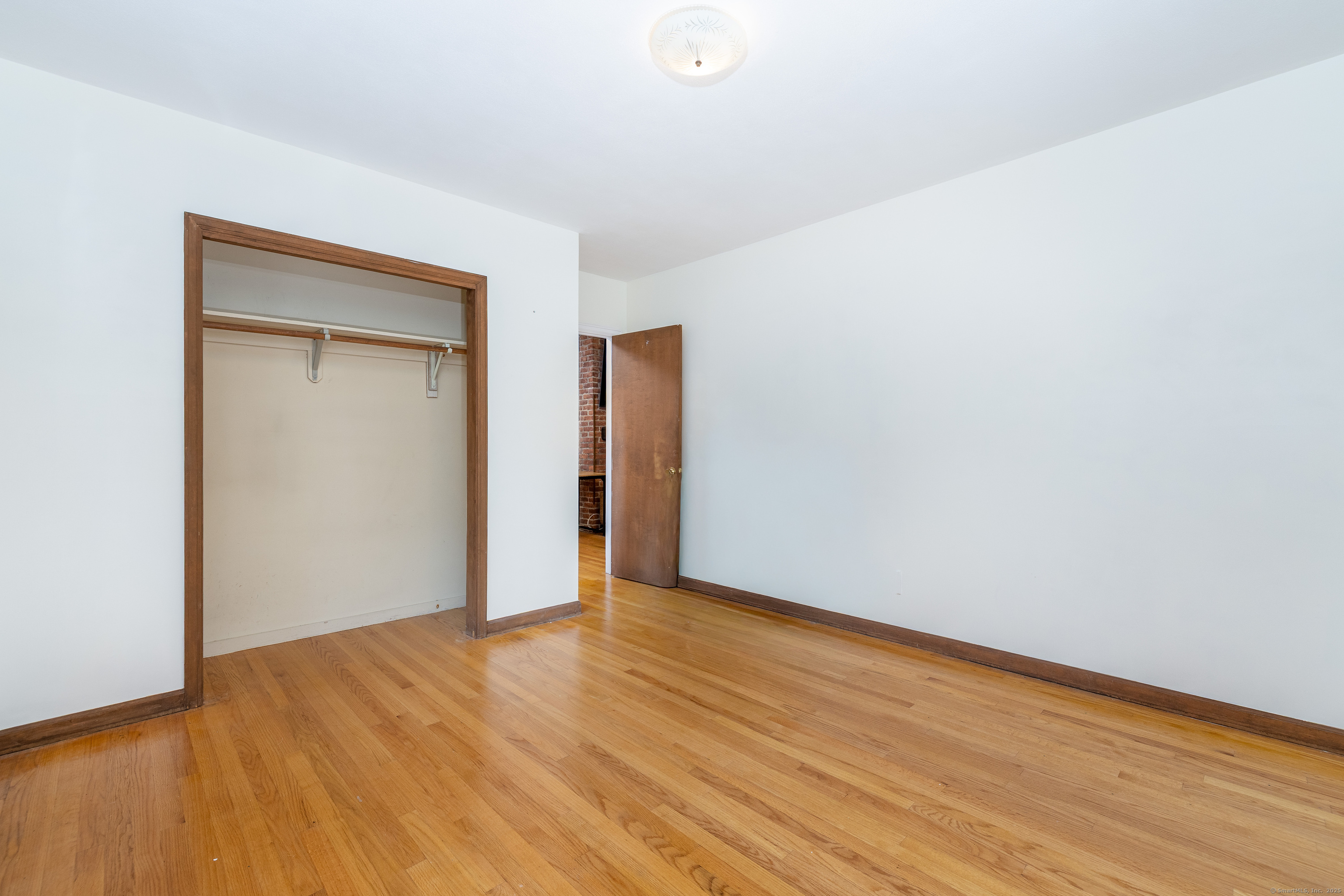 267 Hull Street Bristol, CT 06010 - Photo 15 of 22 a view of an empty room with wooden floor and closet