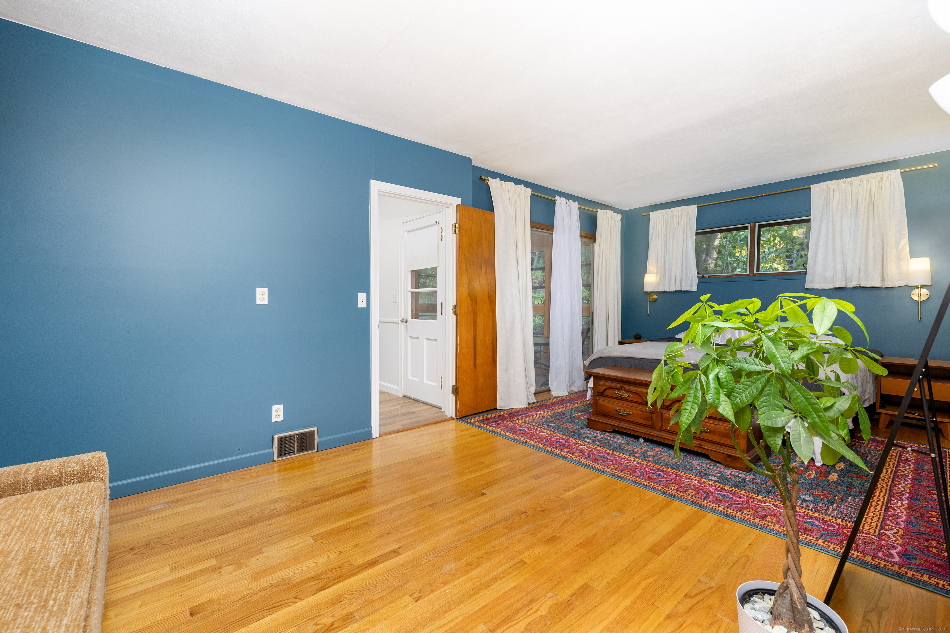 267 Hull Street Bristol, CT 06010 - Photo 19 of 22 a bedroom with a bed table and a potted plant