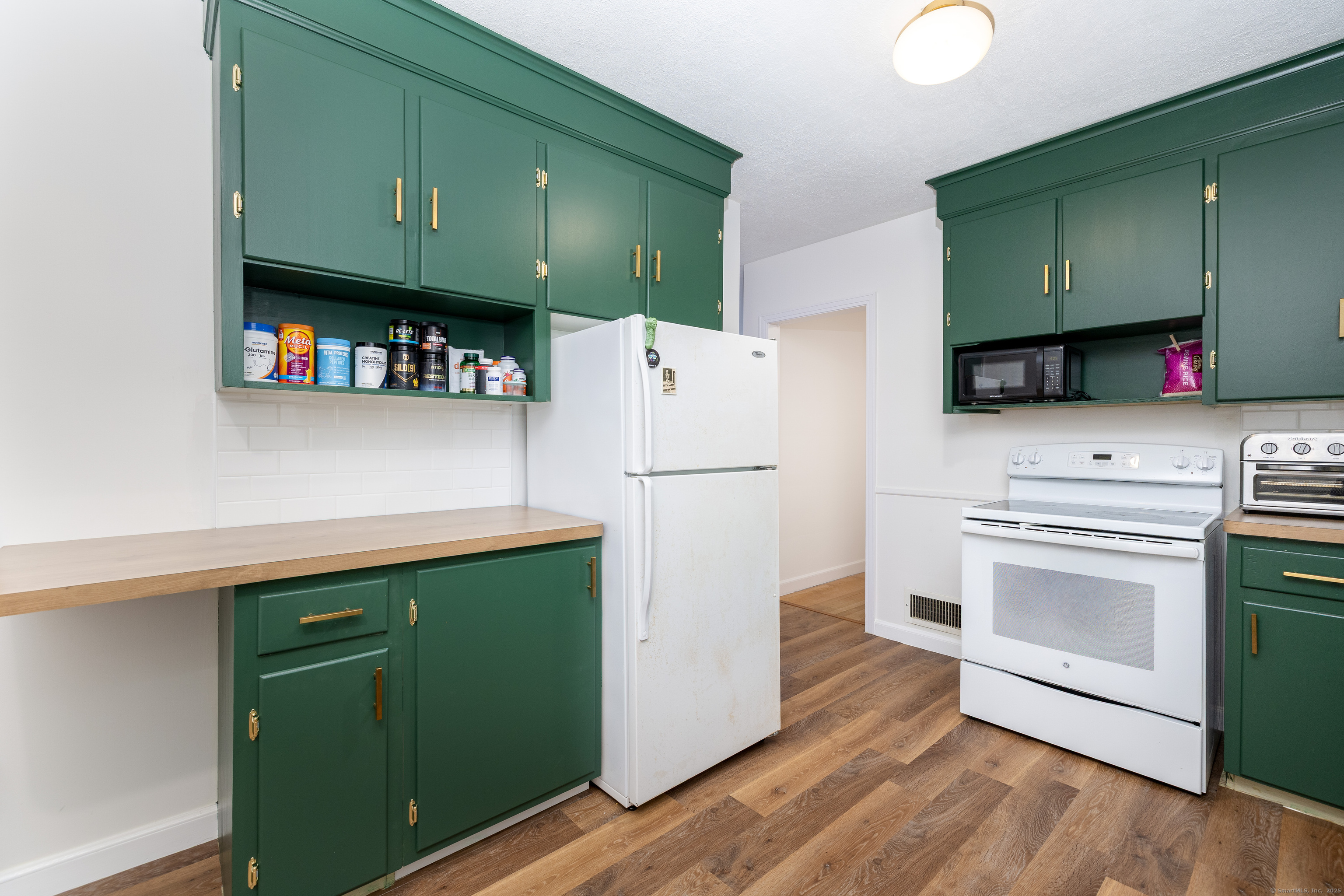 267 Hull Street Bristol, CT 06010 - Photo 6 of 22 a kitchen with stainless steel appliances a refrigerator sink and cabinets