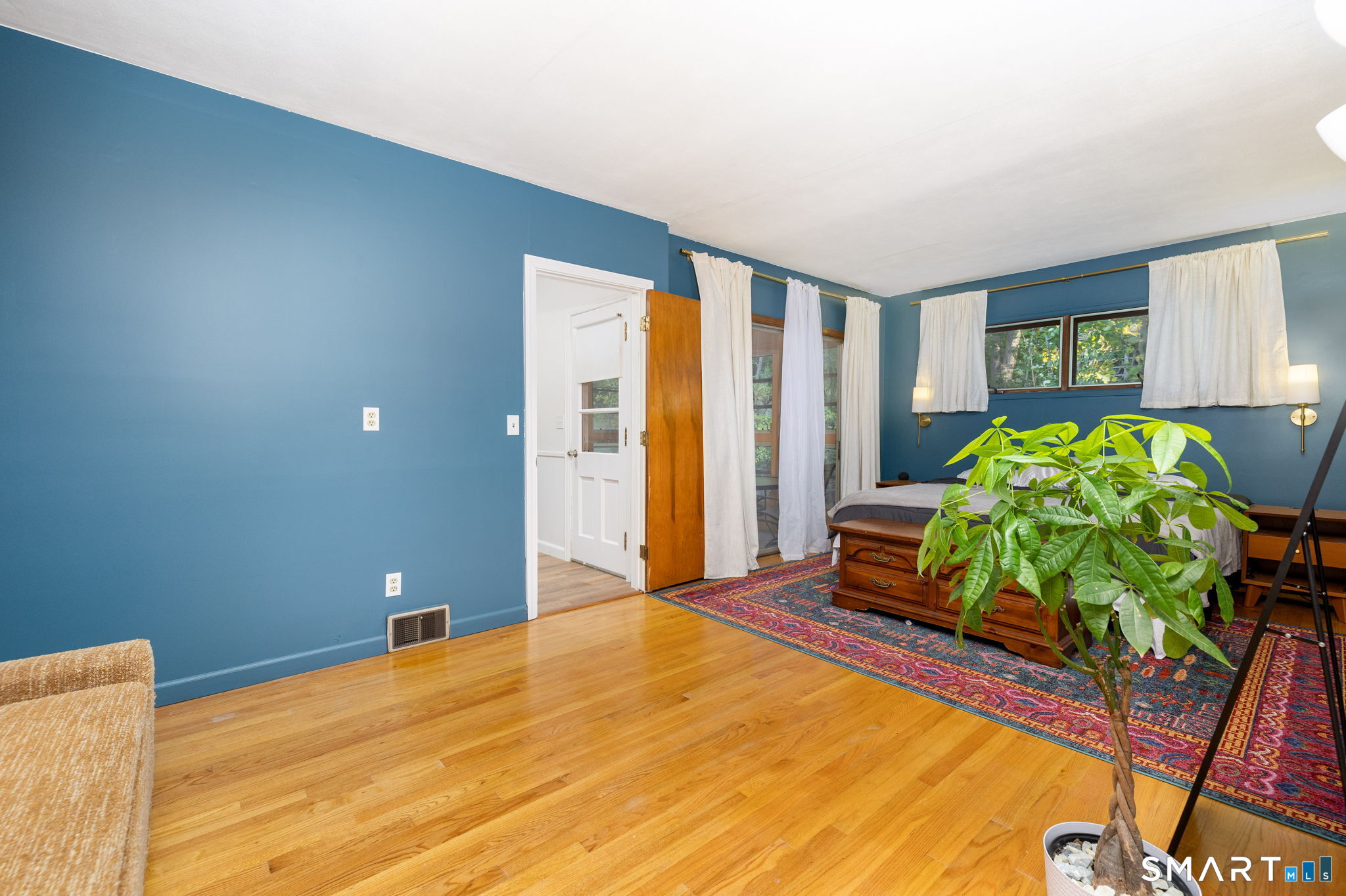 267 Hull Street Bristol, CT 06010 - Photo 9 of 22 a bedroom with a bed table and a potted plant