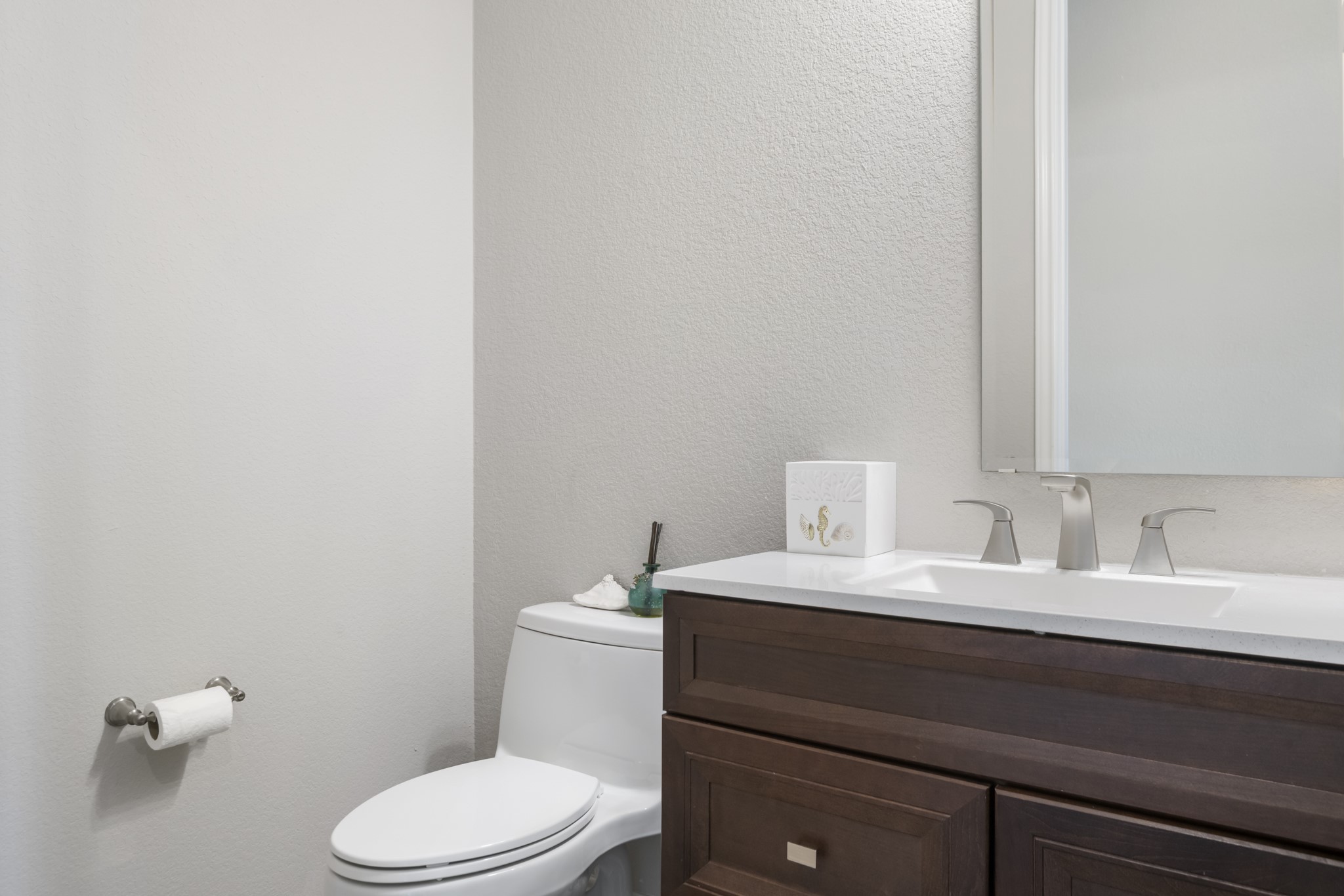 104 Catani Loop Georgetown, TX 78628 - Photo 21 of 34 Bathroom featuring a toilet, a vanity with a white countertop and dark wood cabinetry, and a mirror