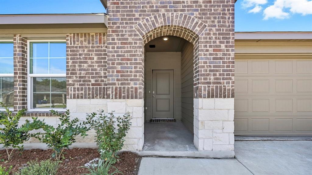 312 Wild Rose Way Princeton, TX 75407 - Photo 19 of 39 a front view of a house with a garden