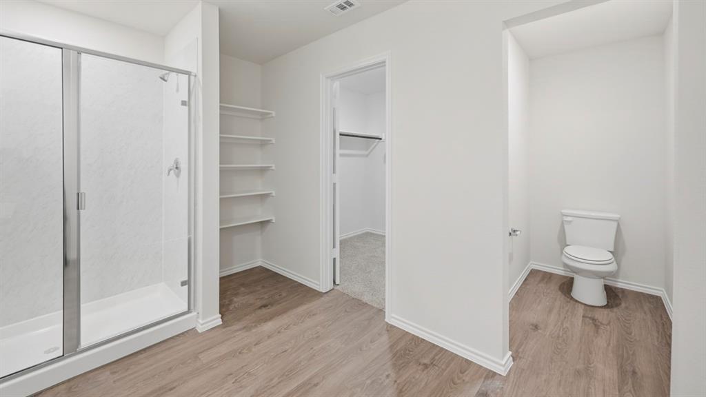 312 Wild Rose Way Princeton, TX 75407 - Photo 3 of 39 a bathroom view of a toilet and a mirror