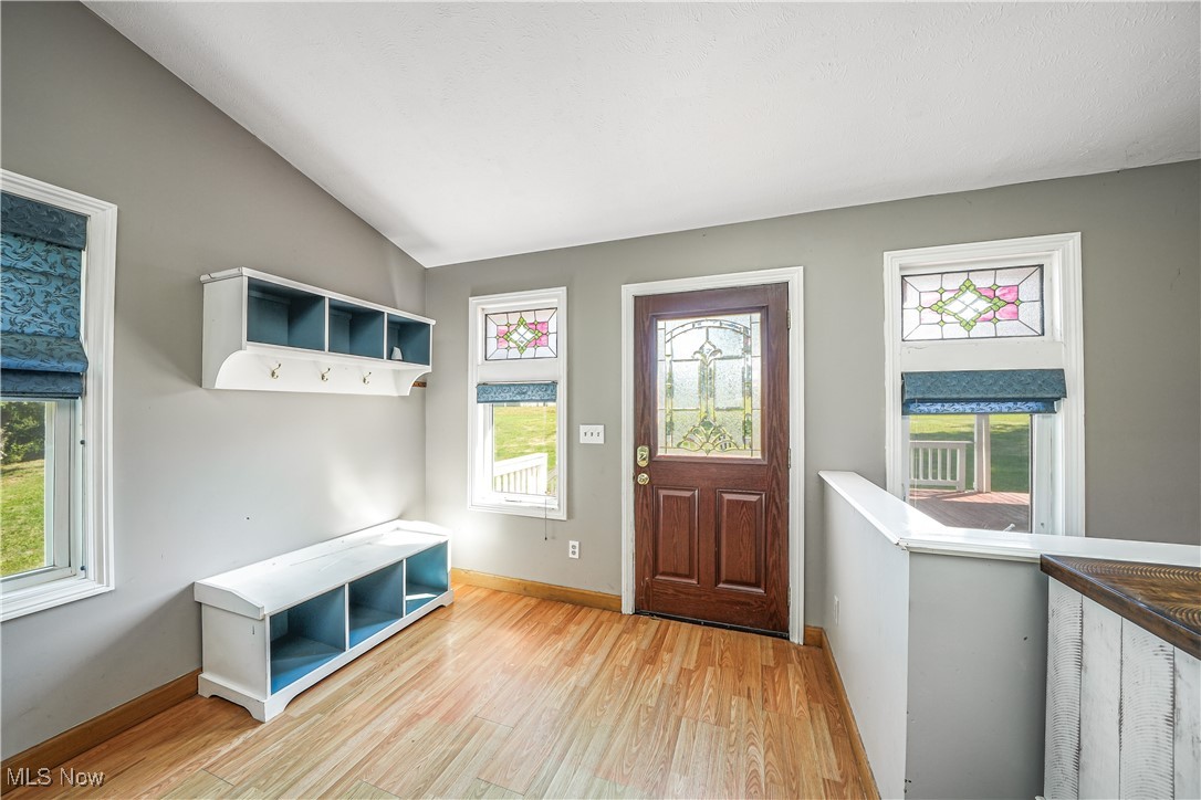 6916 Dewey Road Thompson, OH 44086 - Photo 9 of 49 Mudroom featuring lofted ceiling and light wood-style floors