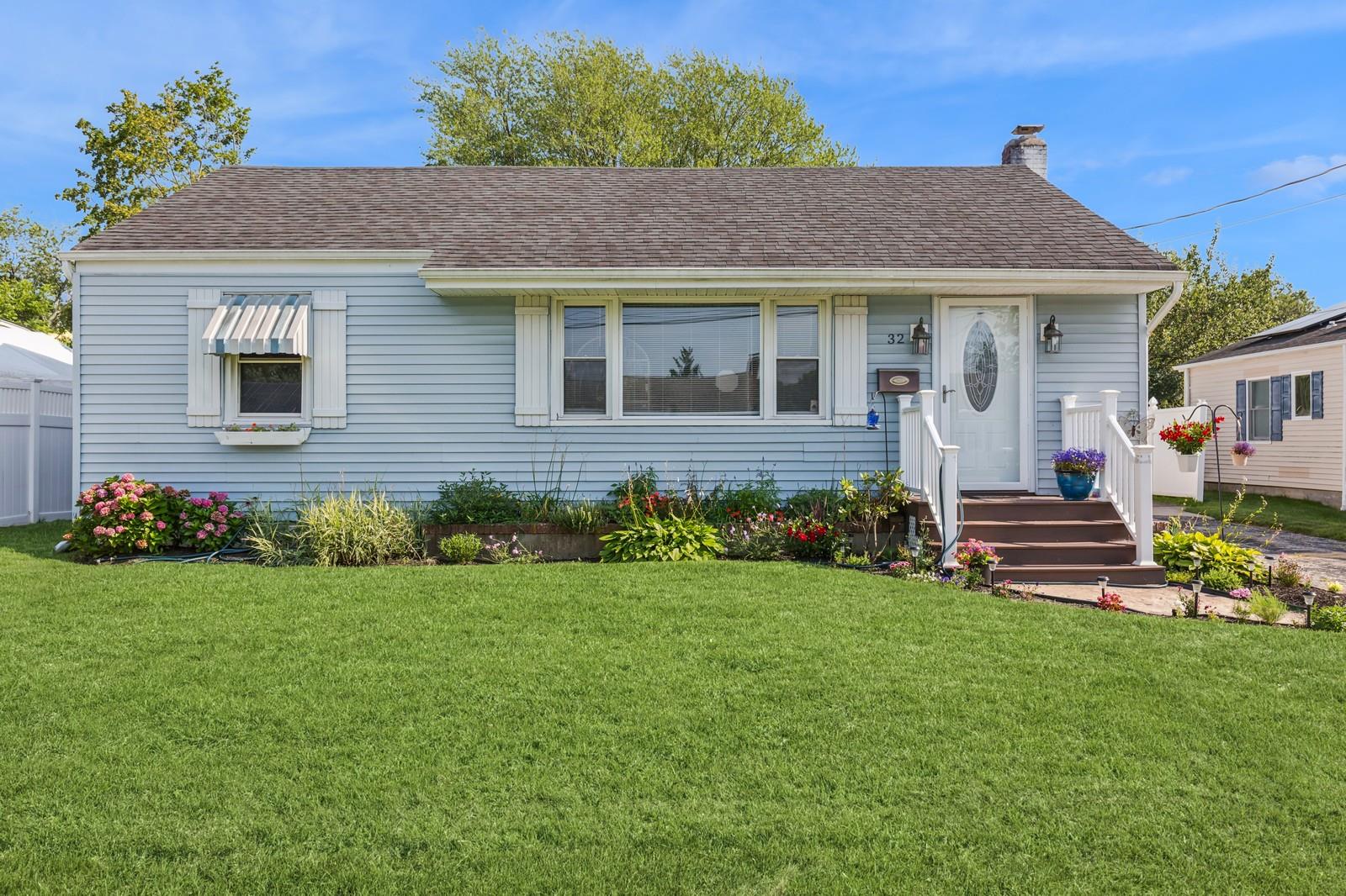 a front view of a house with a garden