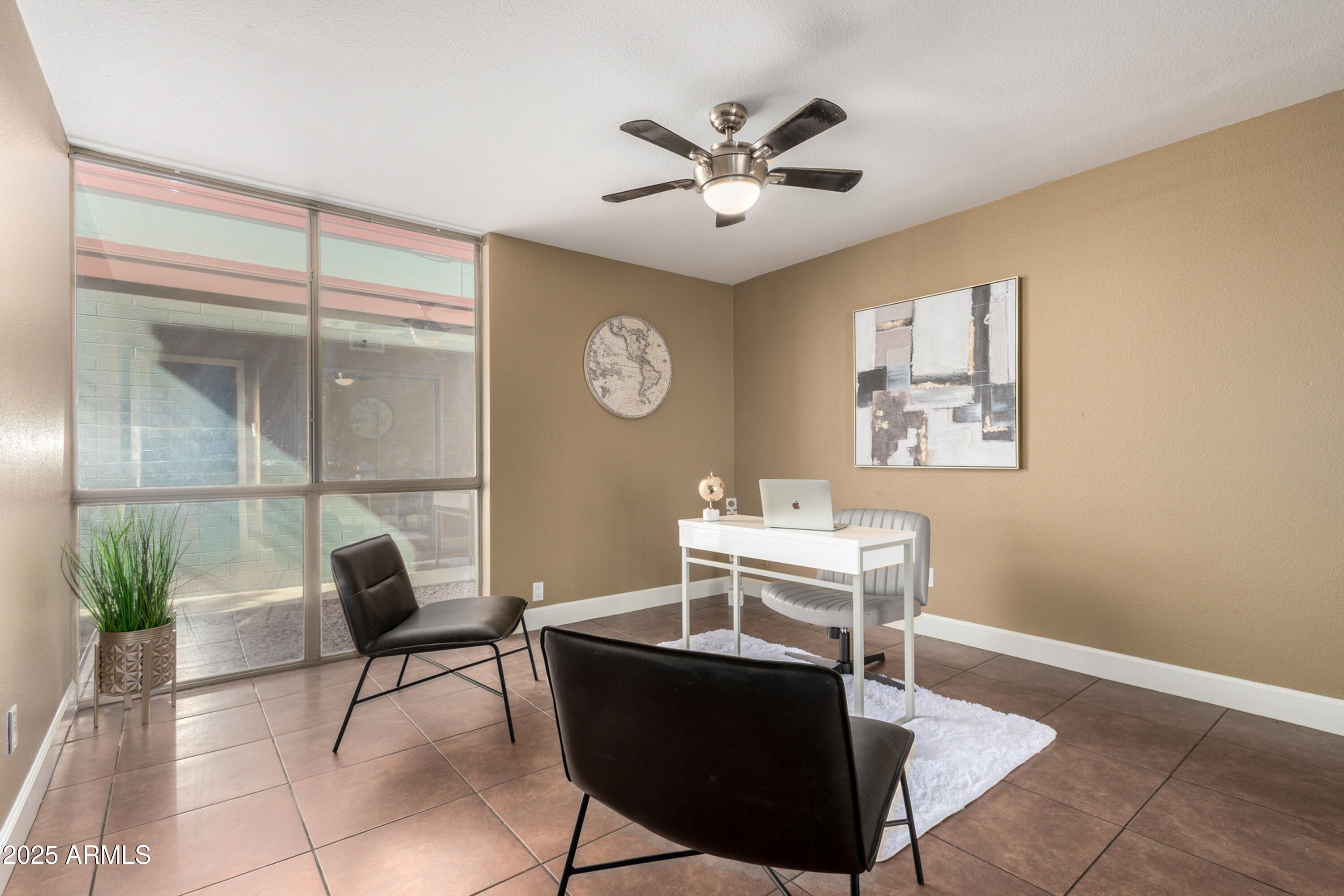 1241 East Medlock Drive, Unit 113 Phoenix, AZ 85014 - Photo 15 of 24 a view of a workspace room with furniture and a potted plant