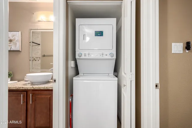 a bathroom with a granite countertop sink a toilet and a mirror