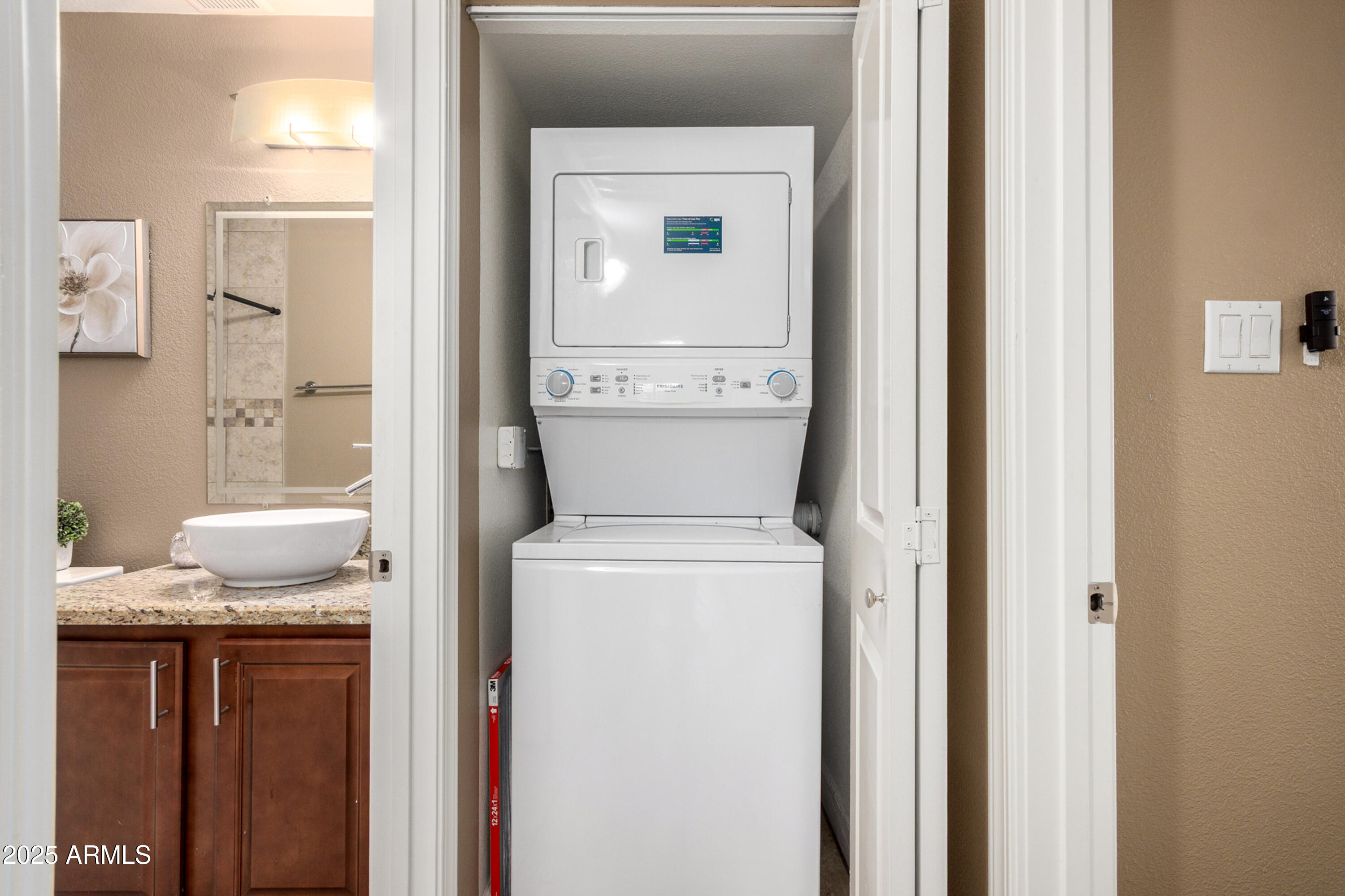 1241 East Medlock Drive, Unit 113 Phoenix, AZ 85014 - Photo 18 of 24 a bathroom with a granite countertop sink a toilet and a mirror