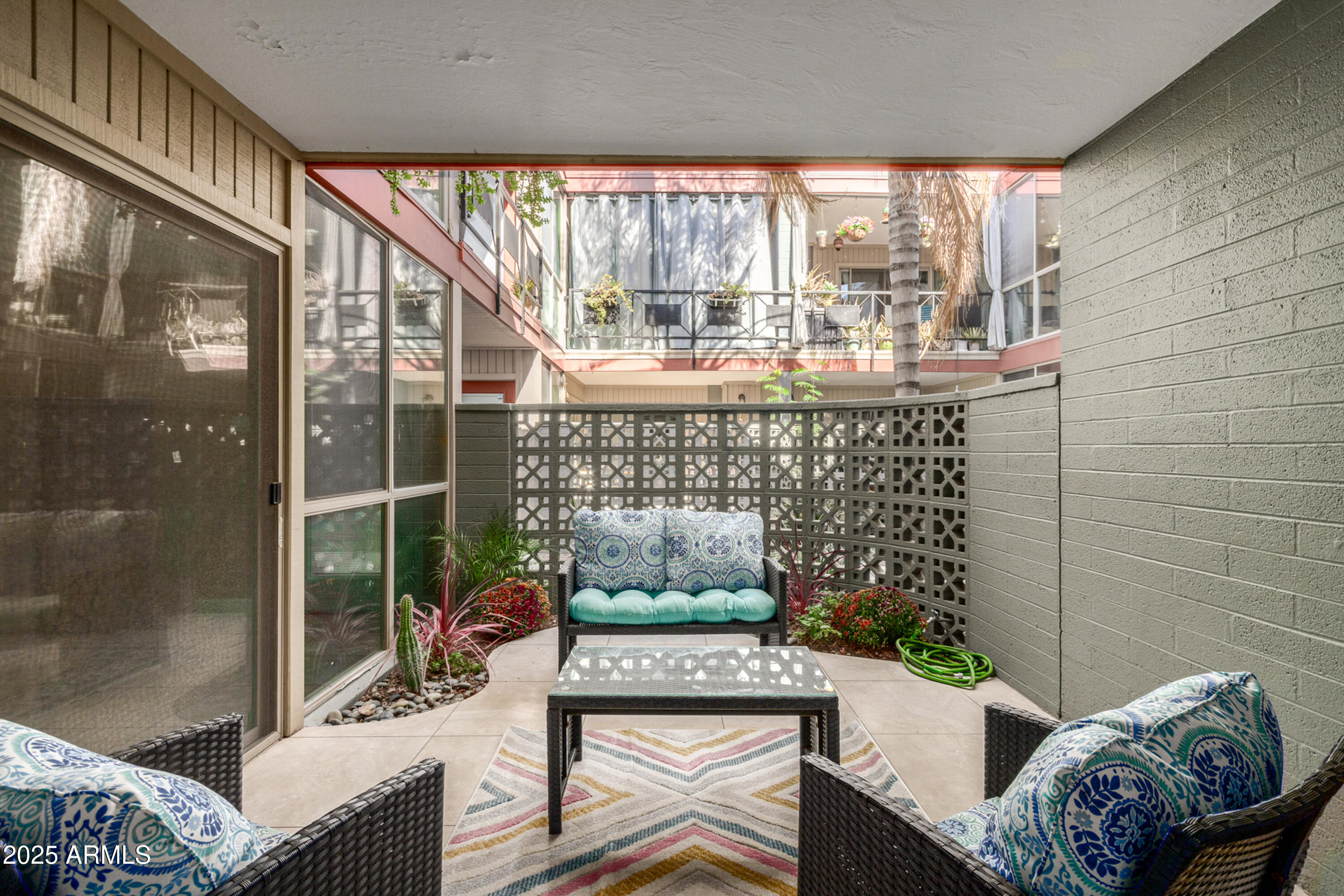 1241 East Medlock Drive, Unit 113 Phoenix, AZ 85014 - Photo 19 of 24 a living room with furniture and a floor to ceiling window