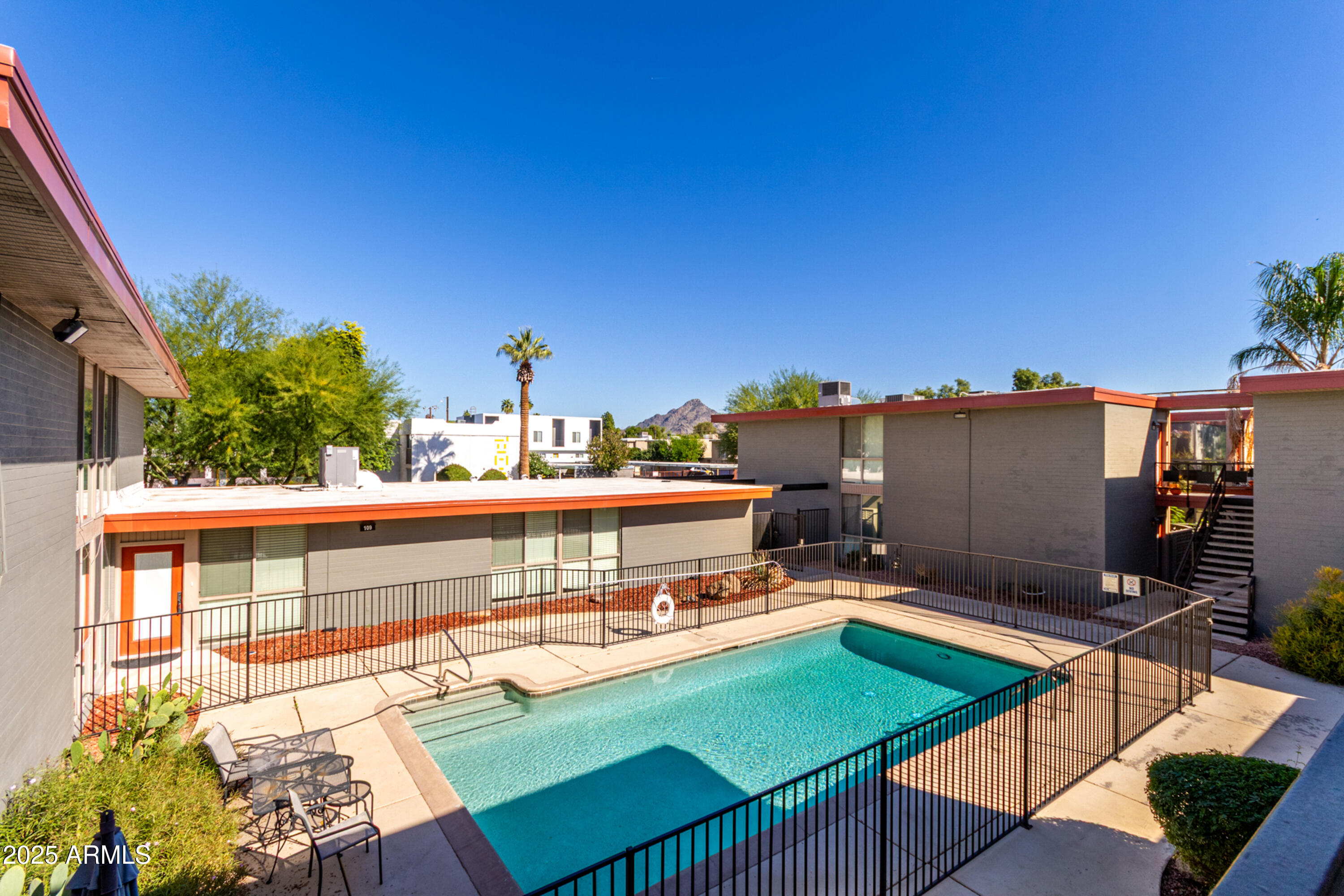 1241 East Medlock Drive, Unit 113 Phoenix, AZ 85014 - Photo 22 of 24 a terrace with outdoor seating and city view