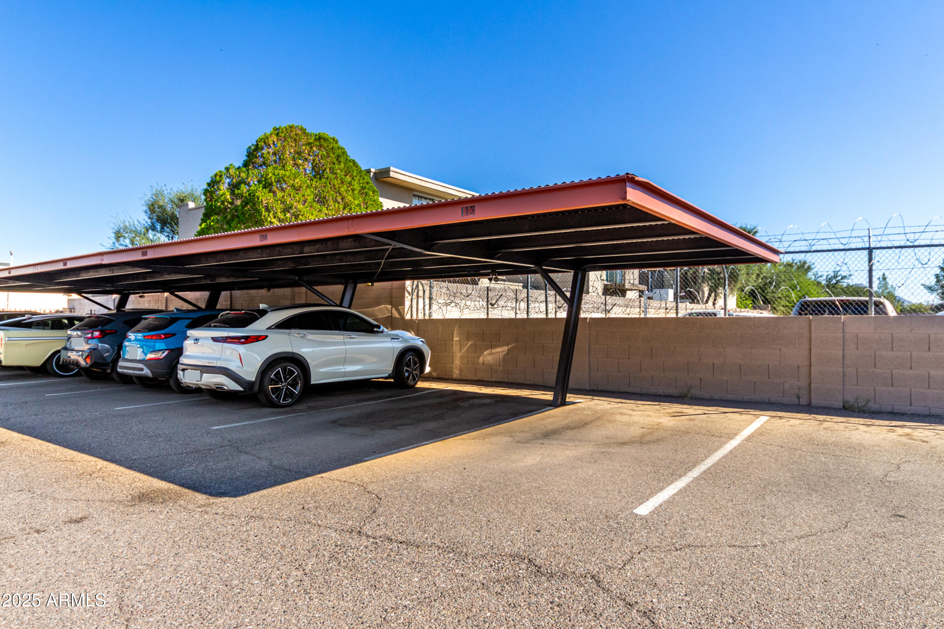 1241 East Medlock Drive, Unit 113 Phoenix, AZ 85014 - Photo 23 of 24 a view of a car park in front of house