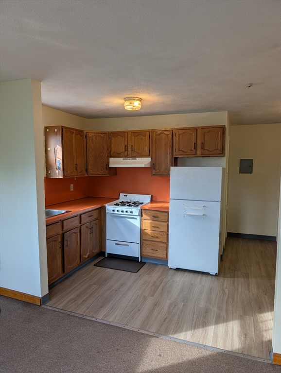 569 Somerville Avenue, Unit 5 Somerville, MA 02143 - Photo 2 of 8 a kitchen with stainless steel appliances a stove and a refrigerator