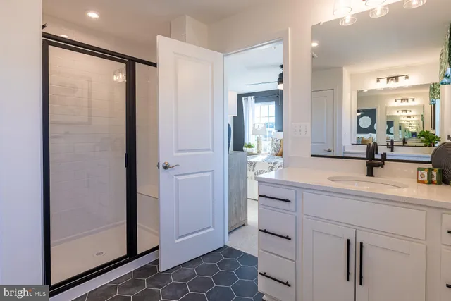 a bathroom with a double vanity sink a mirror and a shower