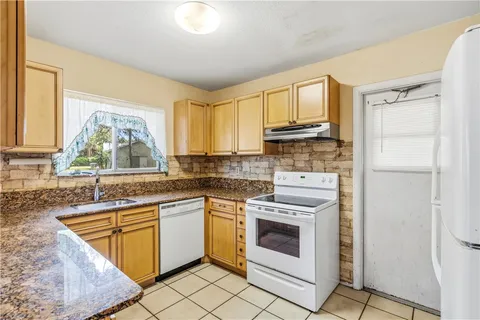 a kitchen with a stove a sink and a microwave