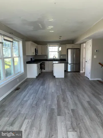 a kitchen with a refrigerator and a sink