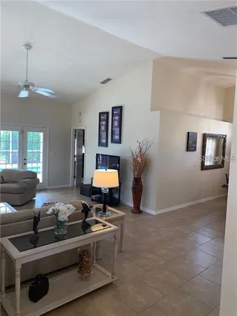 a living room with furniture and a potted plant