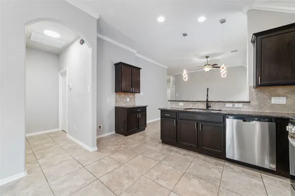 a large kitchen with a large counter top space appliances and a sink