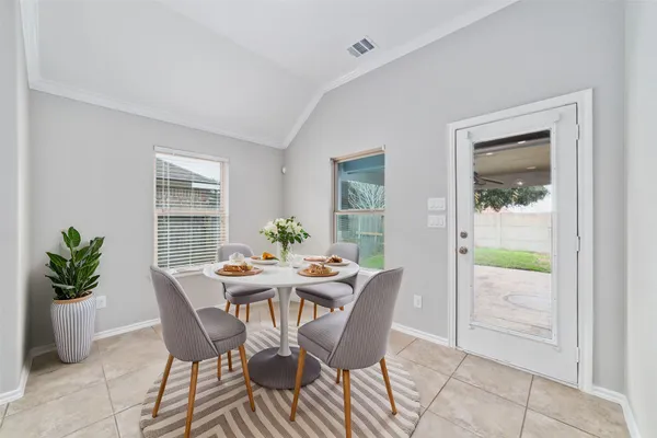 a view of a dining room with furniture and a potted plant