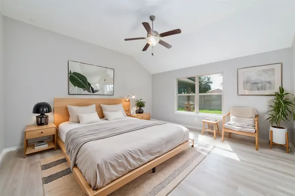 a bedroom with a large bed and a window