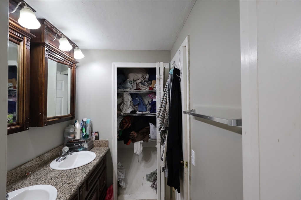 74 Sophia Drive Worcester, MA 01607 - Photo 9 of 15 a en suite bathroom with a granite countertop sink and a mirror